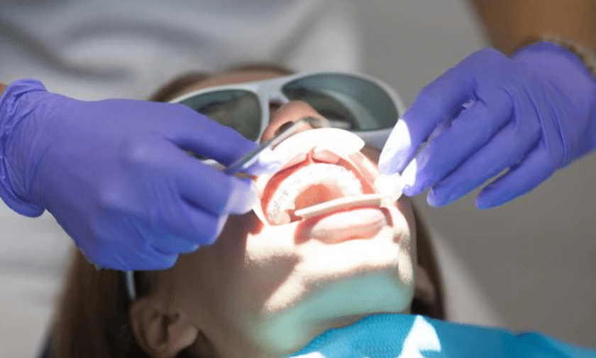 Reasons Why You Should Consider LANAP for Your Dental Procedure (1) Dentist performing LANAP laser gum treatment on patient in Phoenix dental office.