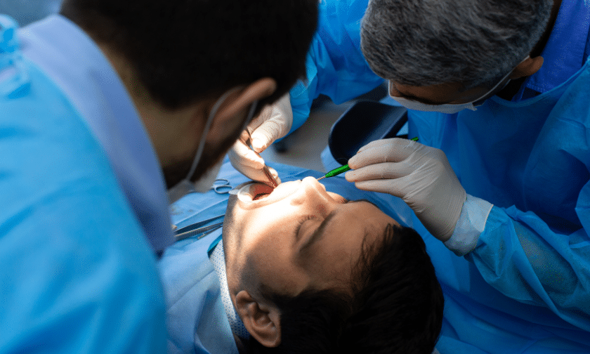 Dental surgeon performing gingival graft procedure on patient in Phoenix.