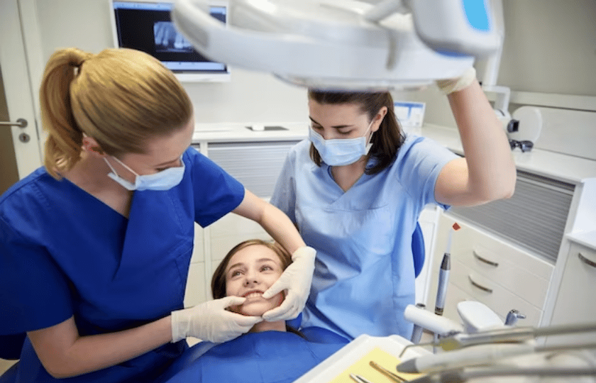 Two dental professionals examine a young patient's teeth during an occlusal therapy consultation in Phoenix.