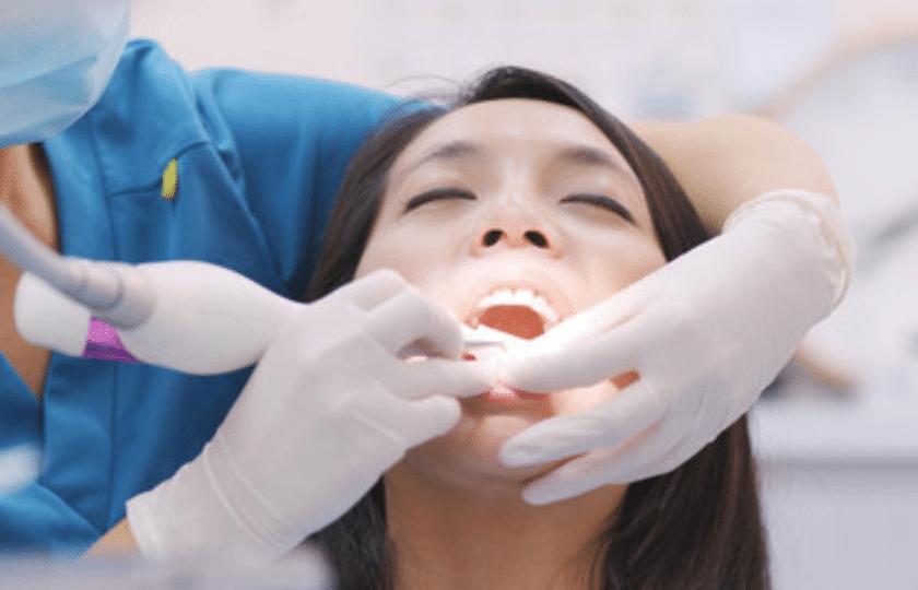 Scaling And Root Planing Dentist performing scaling and root planing treatment on patient's teeth in Phoenix.