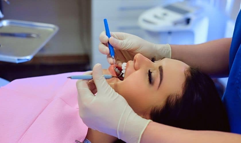Gum Grafting Dentist performing gum grafting procedure on patient in Phoenix dental office.