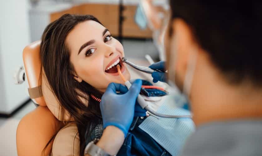 Dentist performing scaling and root planing treatment on patient in Phoenix dental office.