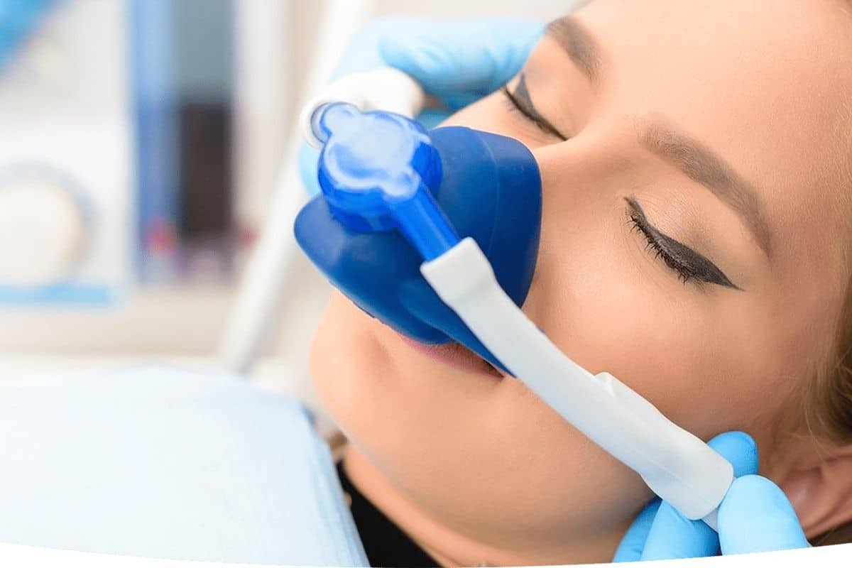 Patient receiving nitrous oxide sedation during dental treatment in Phoenix.