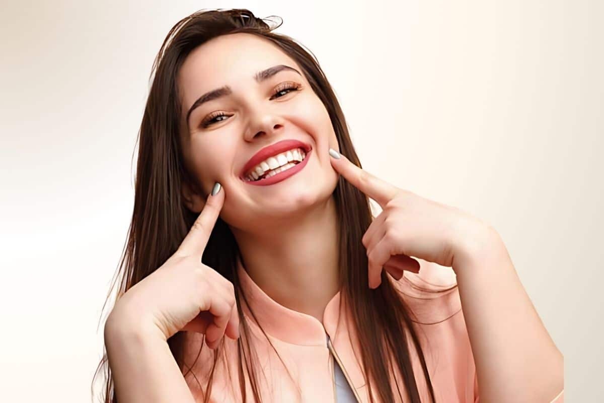 Happy woman smiling with healthy teeth after dental treatment in Phoenix.