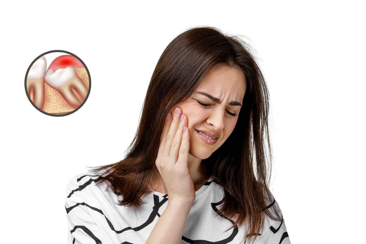 Woman experiencing tooth pain after extraction, holding her cheek in discomfort.